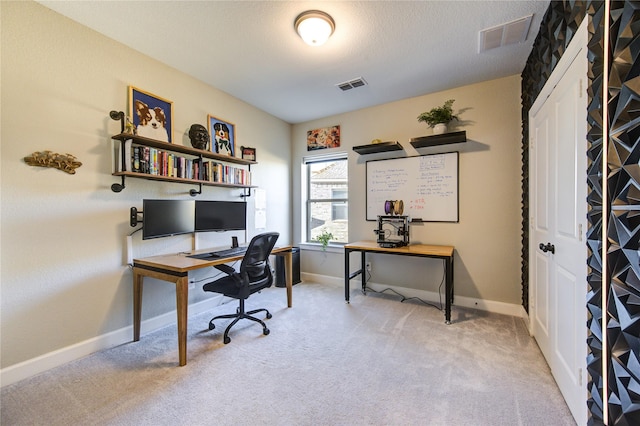 carpeted office space with a textured ceiling