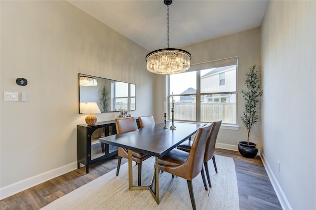 dining room featuring hardwood / wood-style flooring and a chandelier