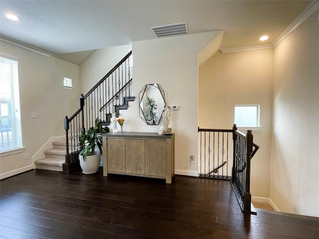 stairs with hardwood / wood-style flooring and ornamental molding