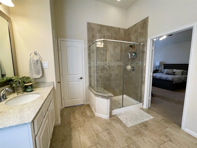 bathroom with vanity and a shower with door