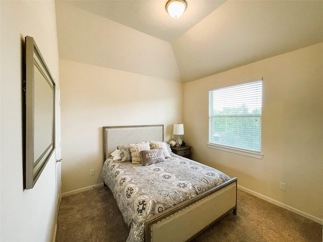 bedroom with lofted ceiling and dark carpet