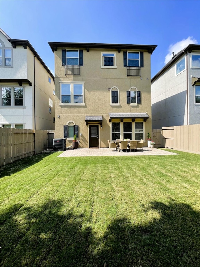 back of property with a patio, a yard, and central air condition unit