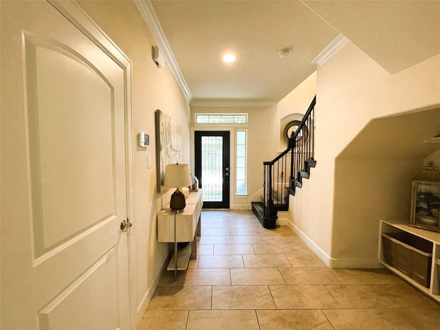 foyer entrance featuring light tile patterned flooring and ornamental molding