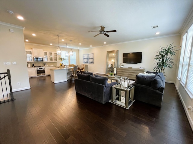 living room with ornamental molding, ceiling fan, and dark hardwood / wood-style flooring