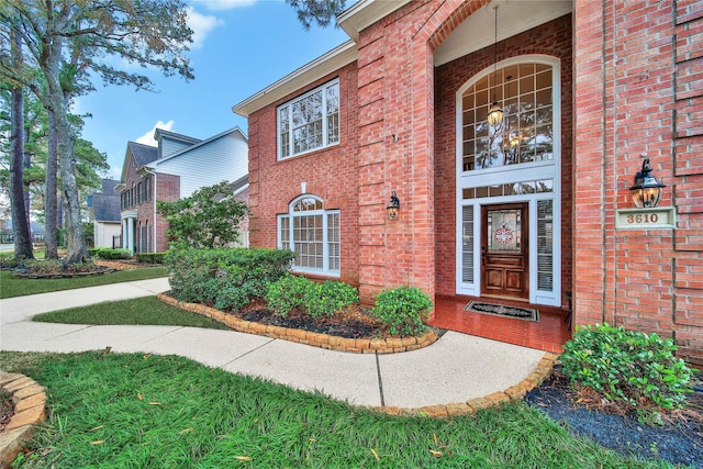 property entrance with a lawn