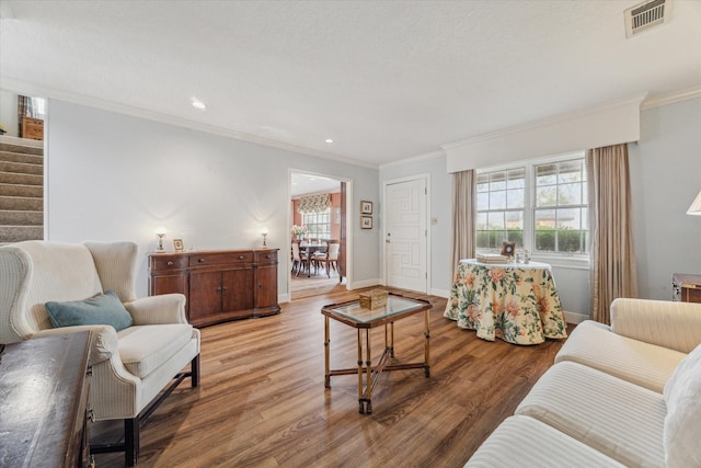 living room with hardwood / wood-style flooring and ornamental molding