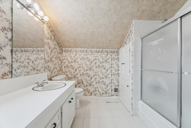 full bathroom with tile patterned floors, toilet, shower / bath combination with glass door, vaulted ceiling, and vanity