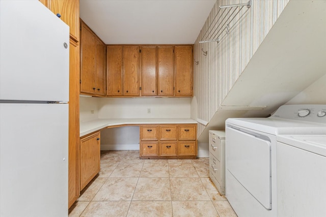 laundry room featuring cabinets, light tile patterned flooring, and washer and dryer