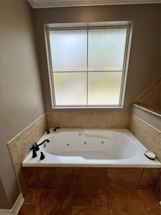 bathroom featuring plenty of natural light and tiled bath