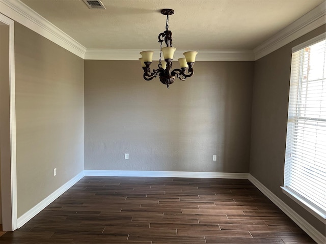 unfurnished room with dark hardwood / wood-style flooring, crown molding, and a chandelier