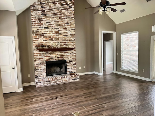 unfurnished living room featuring dark hardwood / wood-style floors, ceiling fan, a fireplace, and high vaulted ceiling