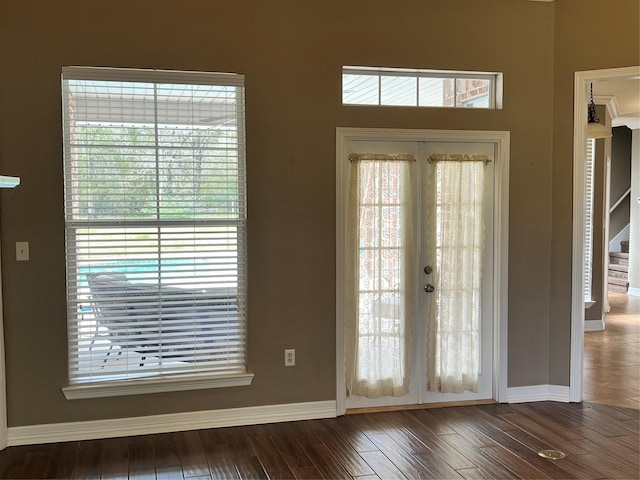 doorway with dark hardwood / wood-style floors and french doors