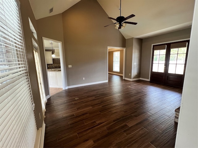 unfurnished living room with french doors, ceiling fan, dark hardwood / wood-style flooring, and high vaulted ceiling