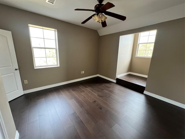 unfurnished room with lofted ceiling, dark hardwood / wood-style floors, and ceiling fan