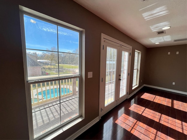 doorway to outside with dark wood-type flooring and french doors