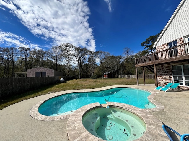 view of pool featuring an in ground hot tub, a patio, and a lawn