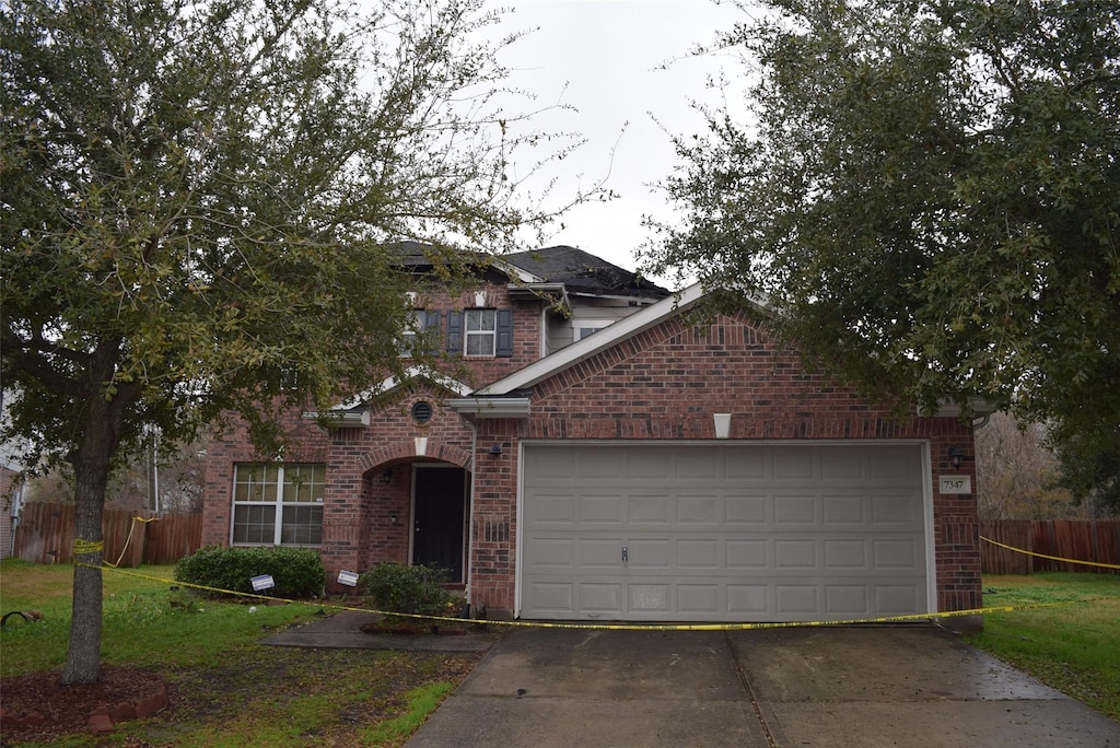 view of front of home featuring a garage and a front yard