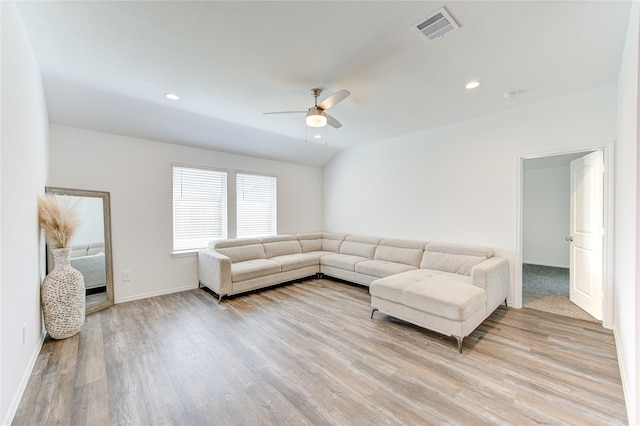 living room with ceiling fan, lofted ceiling, and light hardwood / wood-style floors