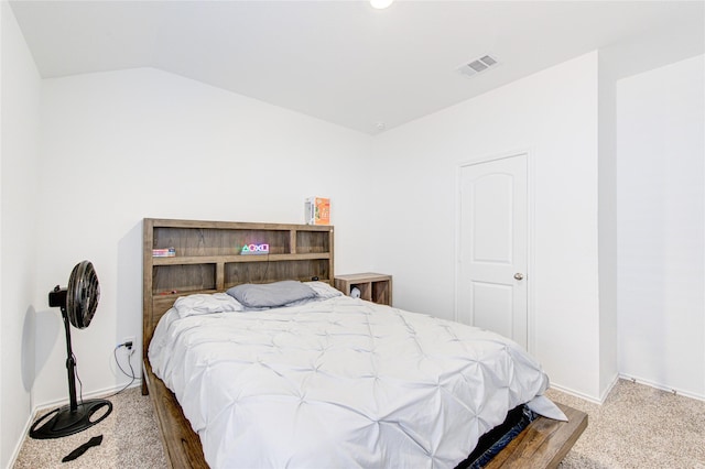 bedroom with lofted ceiling and carpet flooring