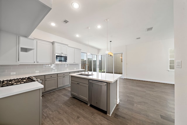 kitchen featuring sink, a kitchen island with sink, hanging light fixtures, gray cabinetry, and stainless steel appliances