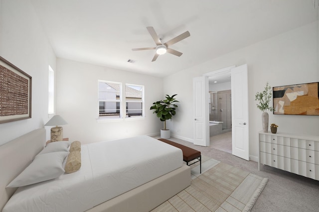 carpeted bedroom featuring ceiling fan and ensuite bath