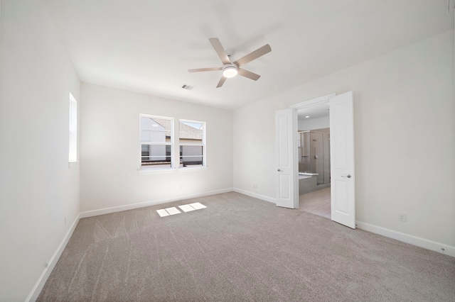 carpeted spare room with ceiling fan