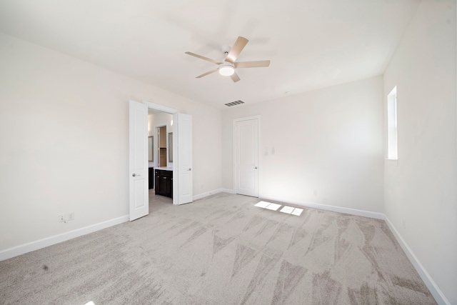 carpeted spare room with ceiling fan