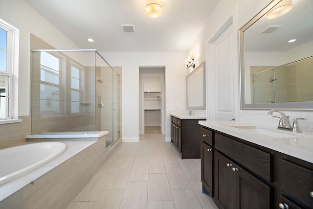 bathroom featuring vanity and plus walk in shower