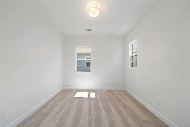 carpeted empty room with a wealth of natural light