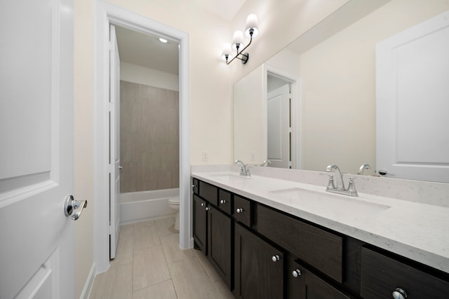 full bathroom featuring vanity, tile patterned floors, toilet, and washtub / shower combination