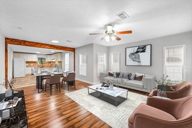 living room featuring ceiling fan and light wood-type flooring