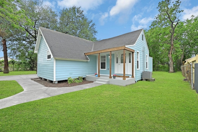 view of front of property with a front yard, central AC unit, and covered porch