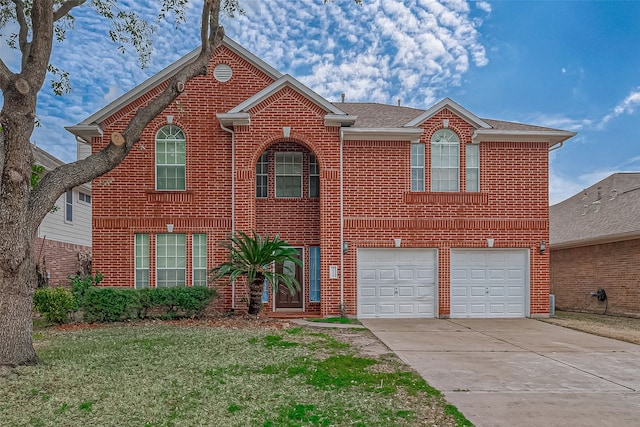 front facade featuring a garage and a front lawn