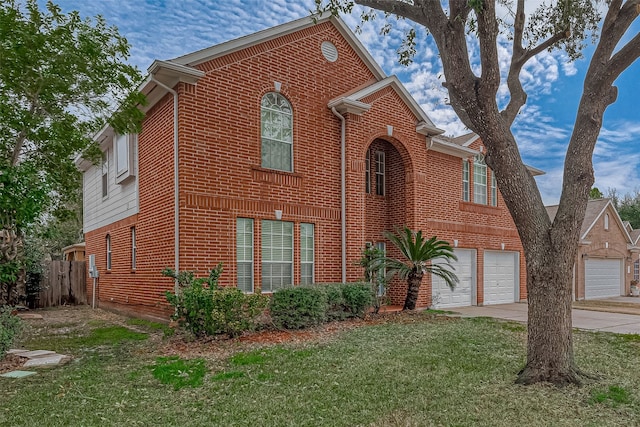 view of property with a garage and a front yard