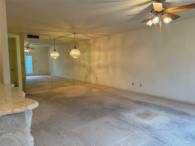 unfurnished room with carpet and ceiling fan