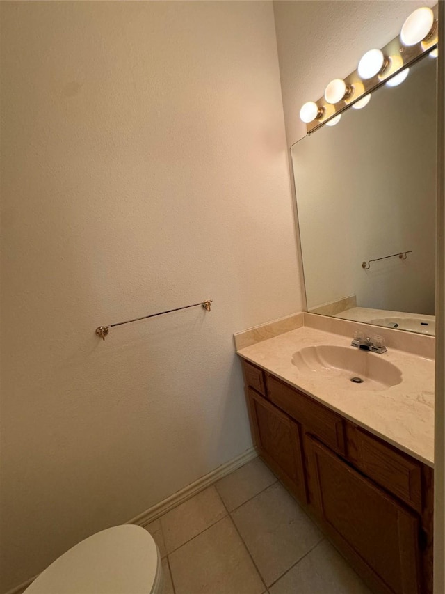 bathroom with vanity, toilet, and tile patterned flooring