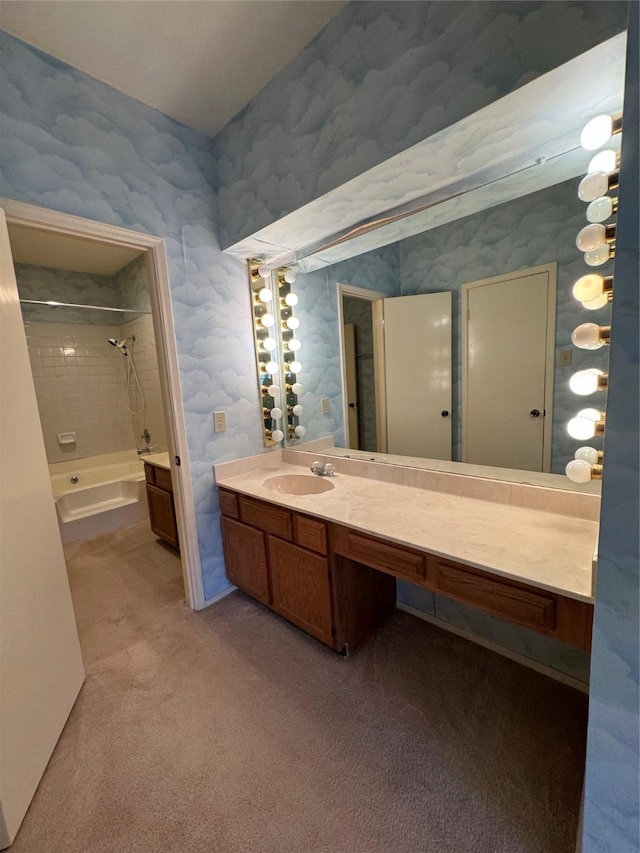 bathroom featuring tiled shower / bath and vanity