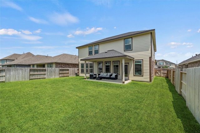 rear view of house with an outdoor living space, a lawn, and a patio area