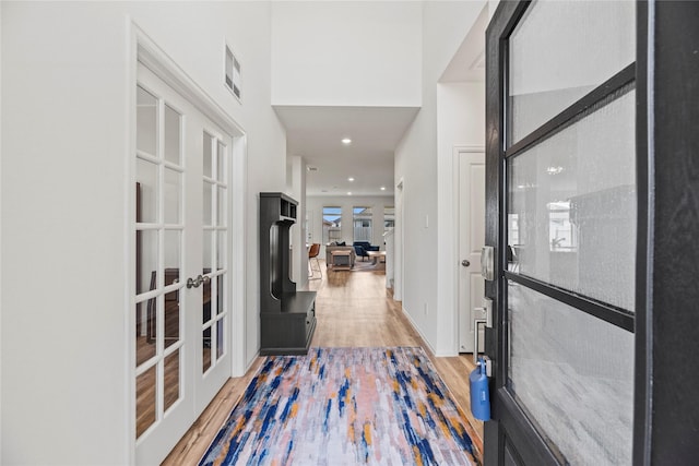 interior space with hardwood / wood-style flooring and french doors