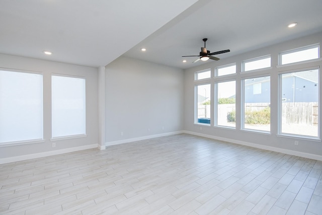 empty room featuring ceiling fan and light hardwood / wood-style flooring