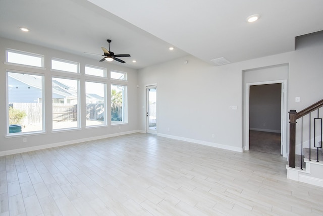 unfurnished living room featuring ceiling fan, a healthy amount of sunlight, and light wood-type flooring