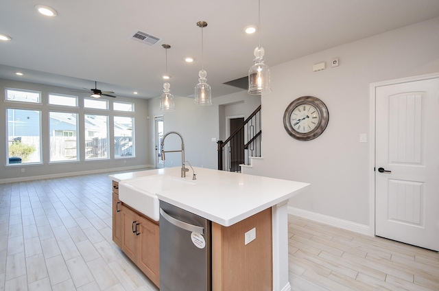 kitchen featuring hanging light fixtures, dishwasher, sink, and a center island with sink