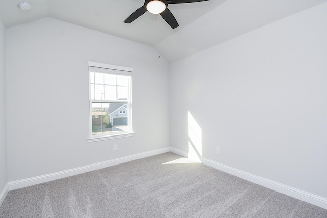 unfurnished room featuring lofted ceiling, carpet, and ceiling fan