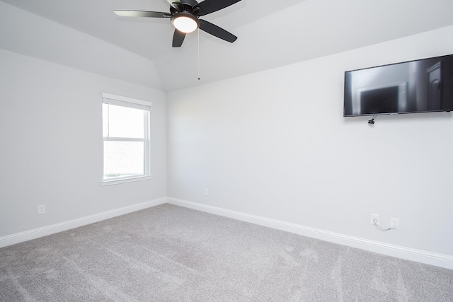 unfurnished room featuring ceiling fan, lofted ceiling, and carpet floors