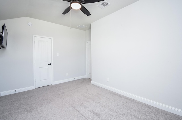 carpeted empty room with vaulted ceiling and ceiling fan