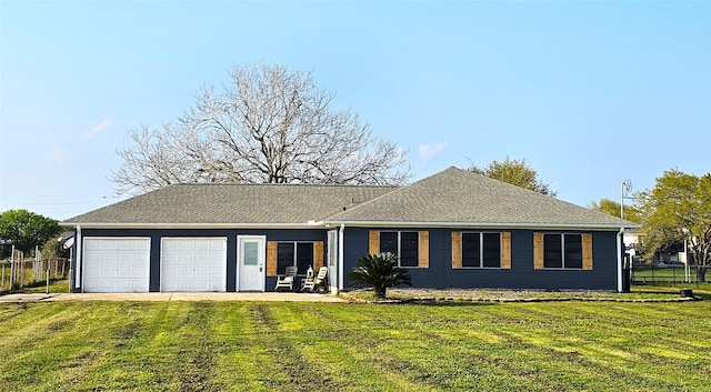 ranch-style house featuring a garage and a front yard