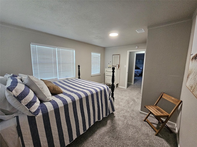 bedroom featuring carpet floors and a textured ceiling