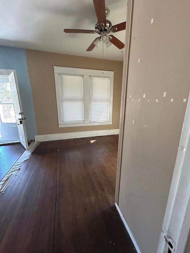 interior space with dark hardwood / wood-style flooring and ceiling fan