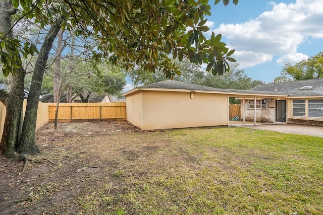 rear view of house with a lawn and a patio area