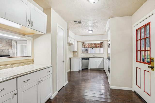 kitchen with white cabinetry, stainless steel dishwasher, and dark hardwood / wood-style flooring